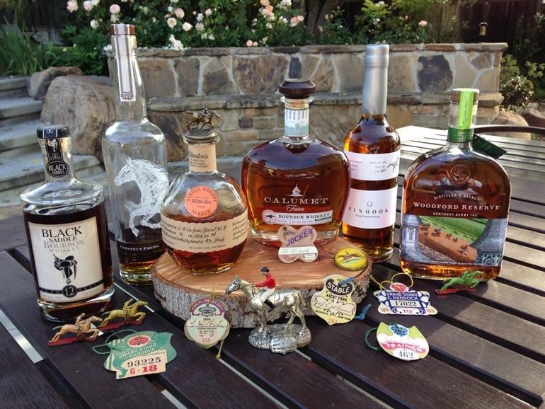 collection of bourbon bottles for kentucky derby