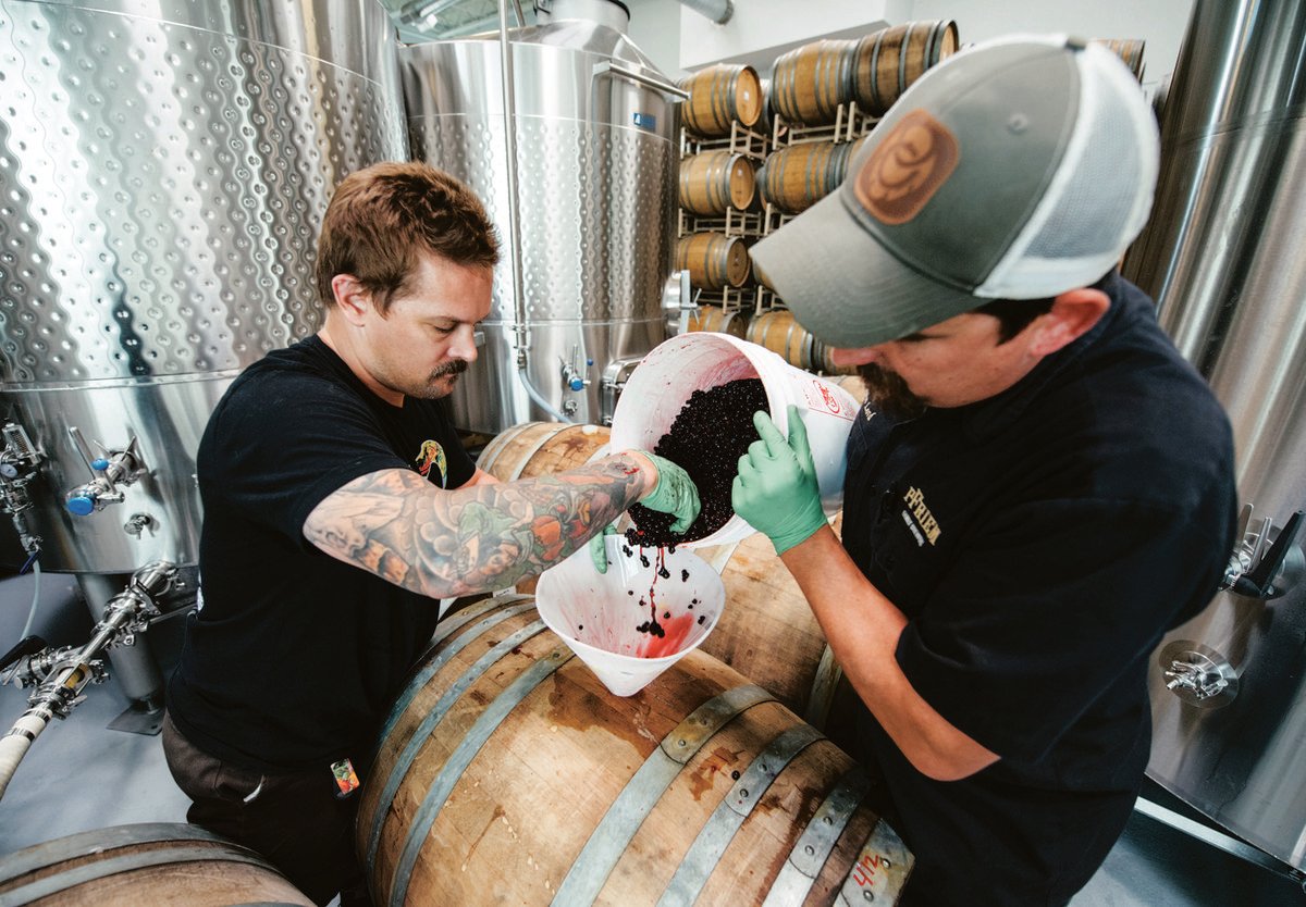 pfriem brewers add berries to a barrel during the brewing process
