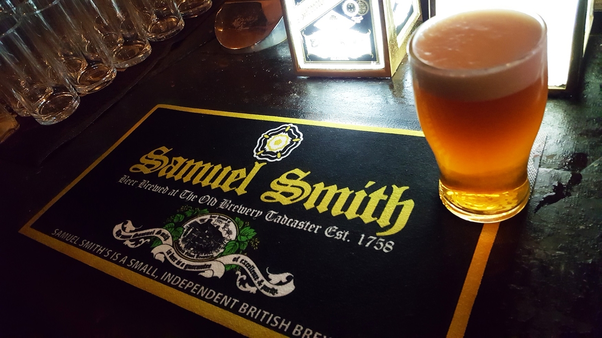 samuel smith's old brewery bitter sitting on a branded bar mat